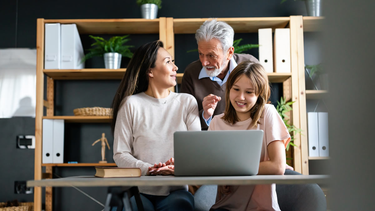Man, Woman, and girl in front of laptop