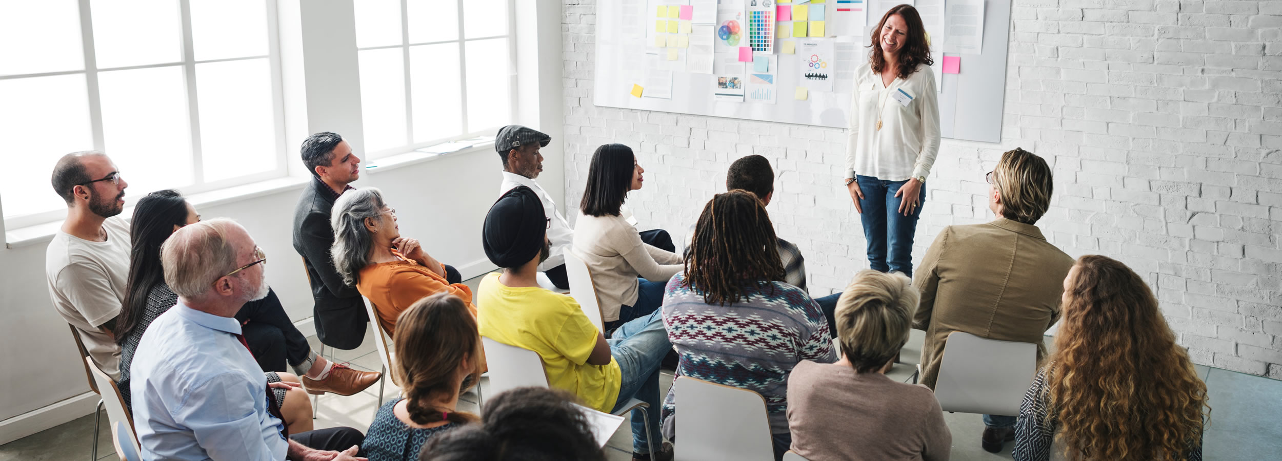 Woman standing in front of group, professional training
