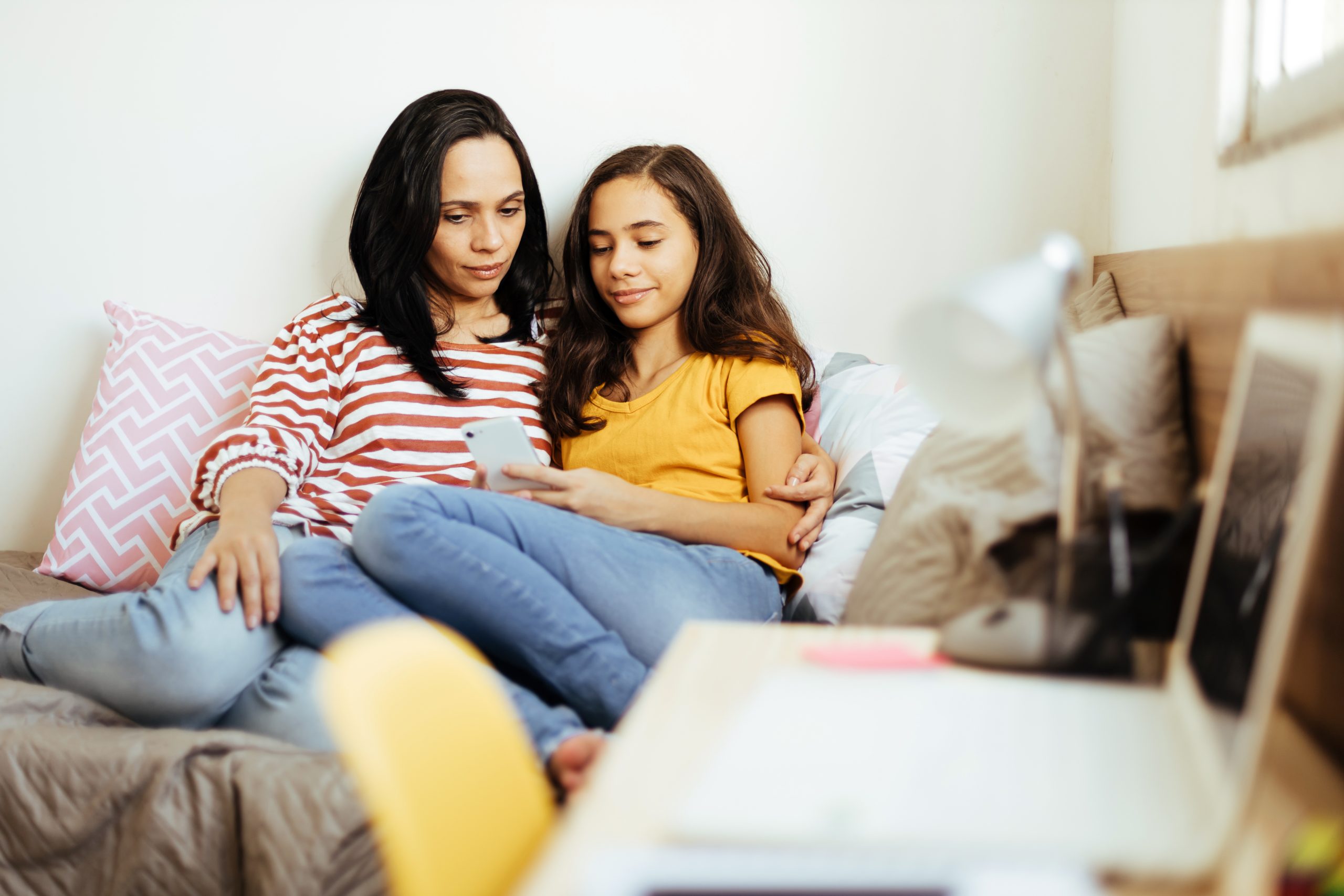 Single parenthood. Mother and daughter spending time together at home.